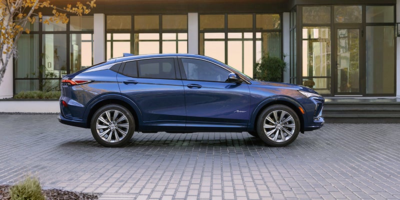 A blue Buick Enclave, parked outside a residence