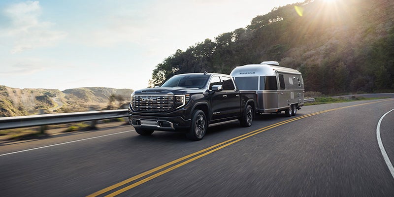Black GMC Sierra 1500, hauling a camper