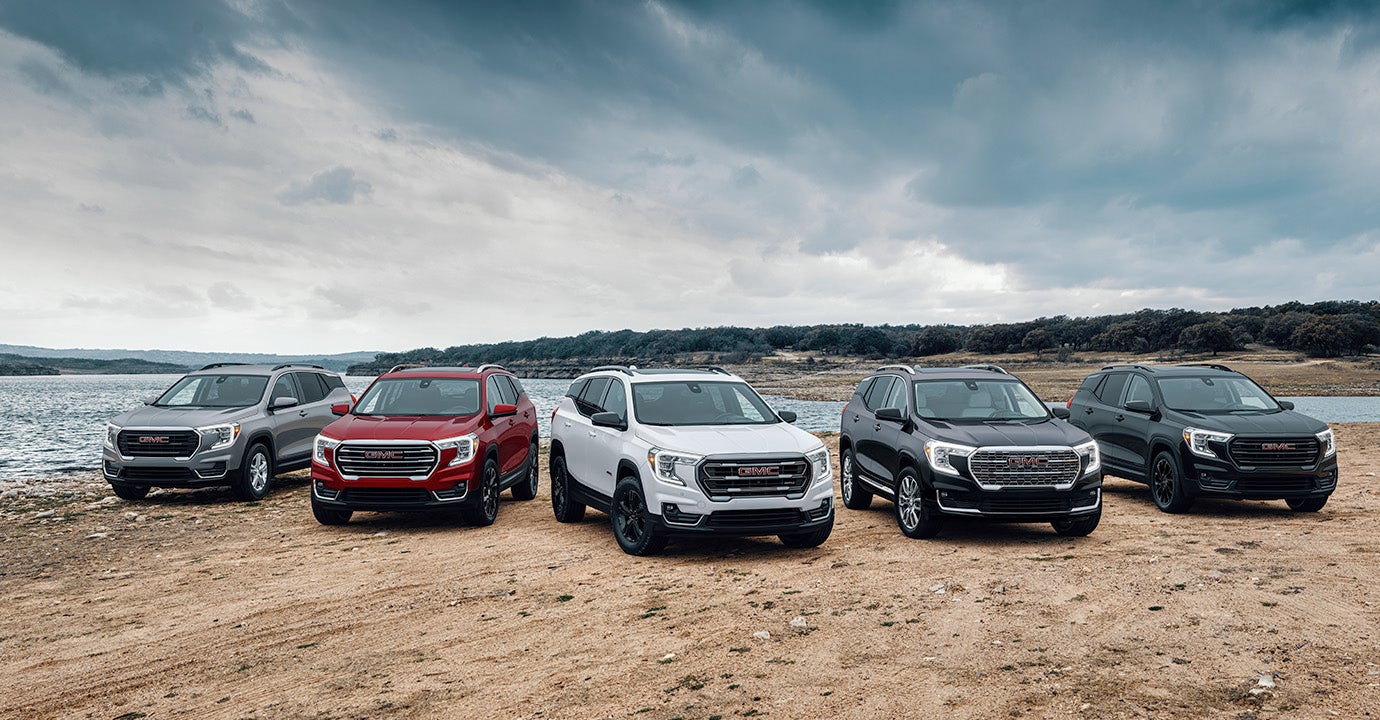 A lineup of GMC Terrain's parked on a beach